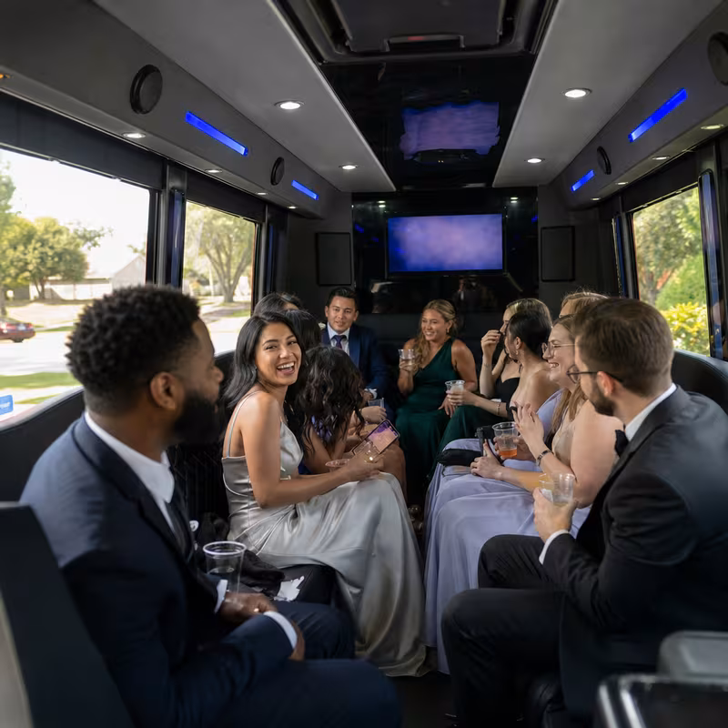 Wedding guests seated inside an Irving party bus