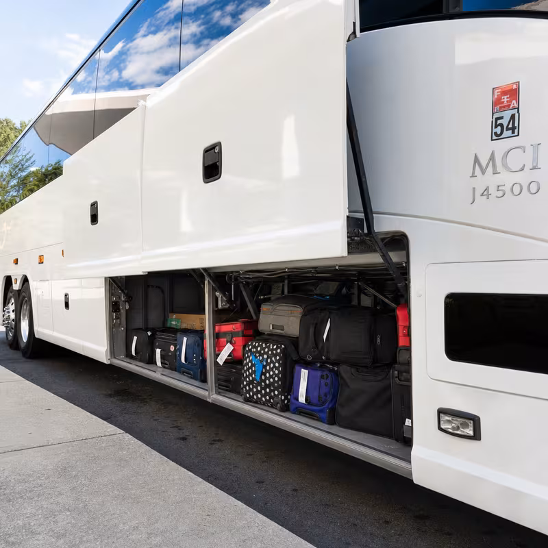 Party bus interior with wraparound leather seating and LED lighting in Irving