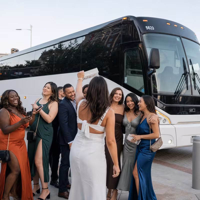 Passengers loading luggage while boarding an Irving group shuttle