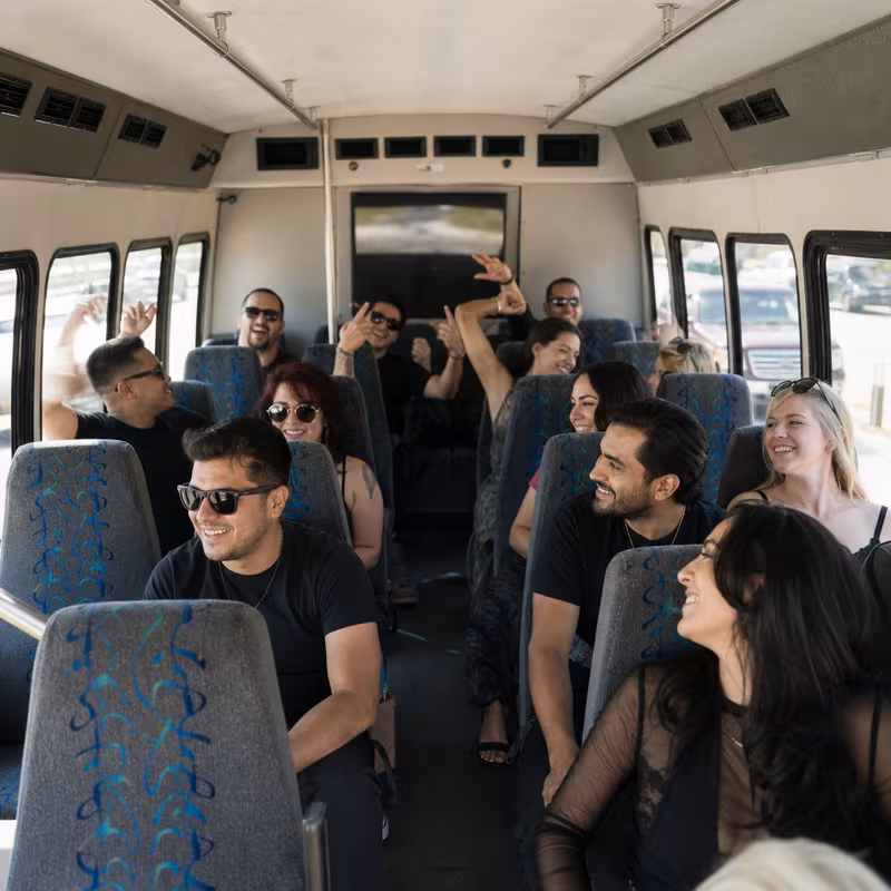 Party bus interior with wraparound leather seating and LED lighting in Irving