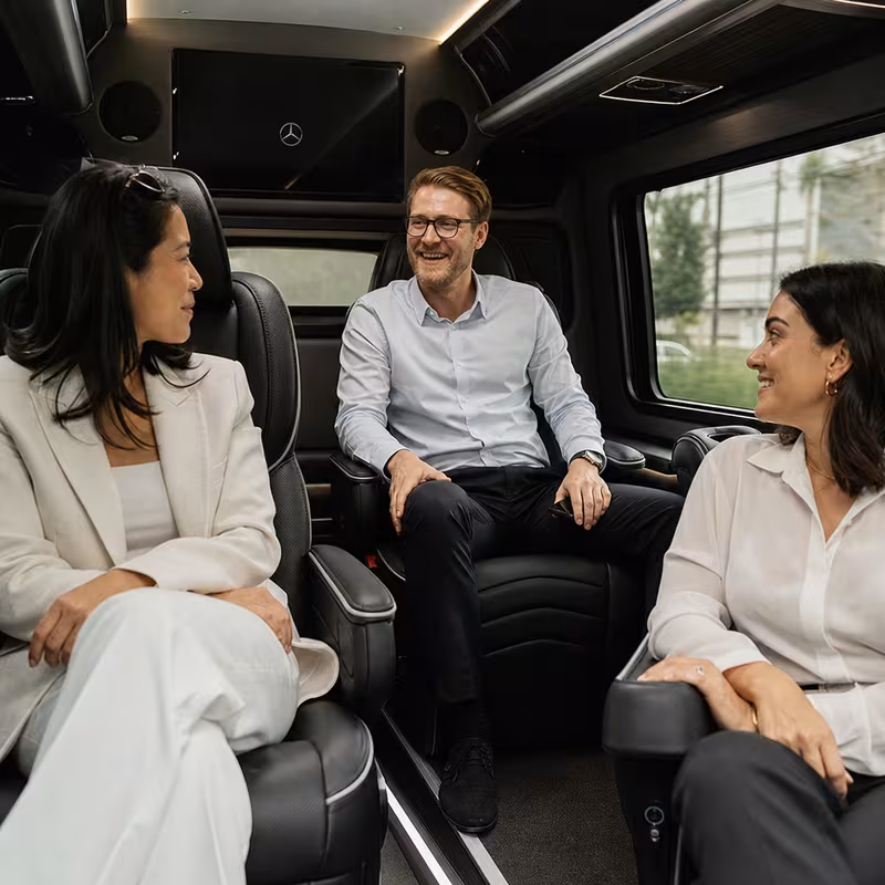 Group boarding a white charter bus for Corporate Transportation transportation in Irving