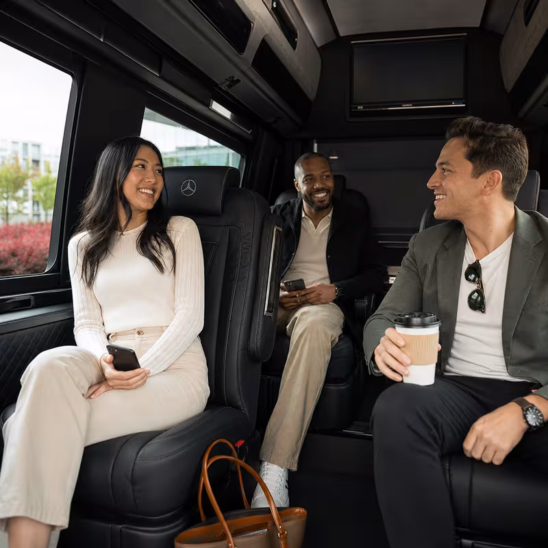 Passengers loading luggage while boarding an Irving group shuttle