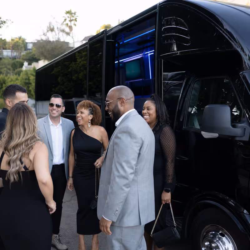 Passengers loading luggage while boarding an Irving group shuttle