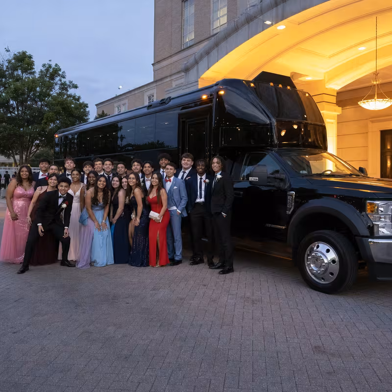 Party bus interior with wraparound leather seating and LED lighting in Irving