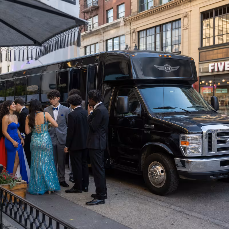 Passengers loading luggage while boarding an Irving group shuttle