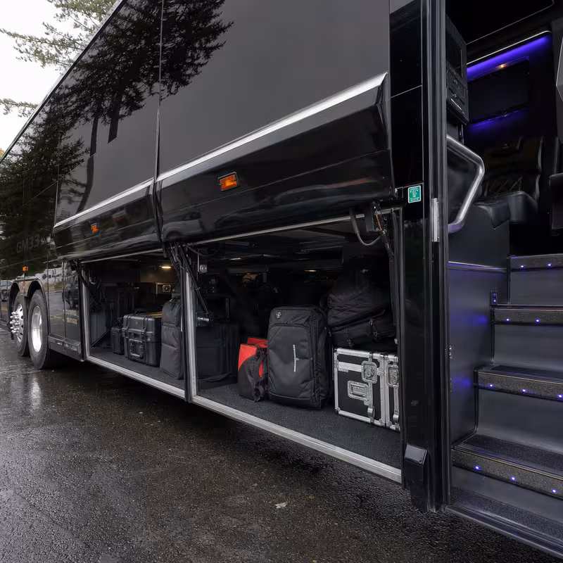 Party bus interior with wraparound leather seating and LED lighting in Irving