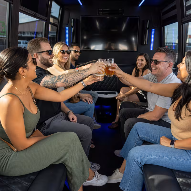 Group boarding a white charter bus for Winery & Brewery Tour Transportation transportation in Irving