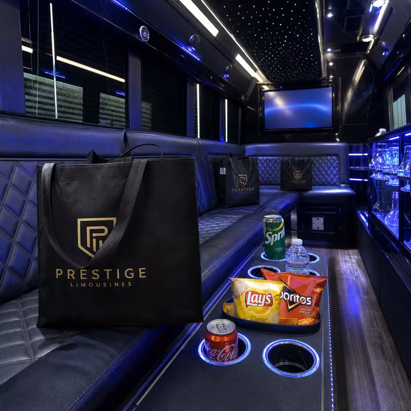 Party bus interior with wraparound leather seating and LED lighting in Irving